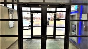 Glass aluminum vestibule entrance at a commercial bank building